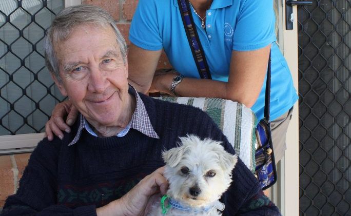 Regency Park resident Graeme Parkinson and employee Jodie Bygroves with new village superstar Marley. Regency Park resident Graeme Parkinson and employee Jodie Bygroves with new village superstar Marley.